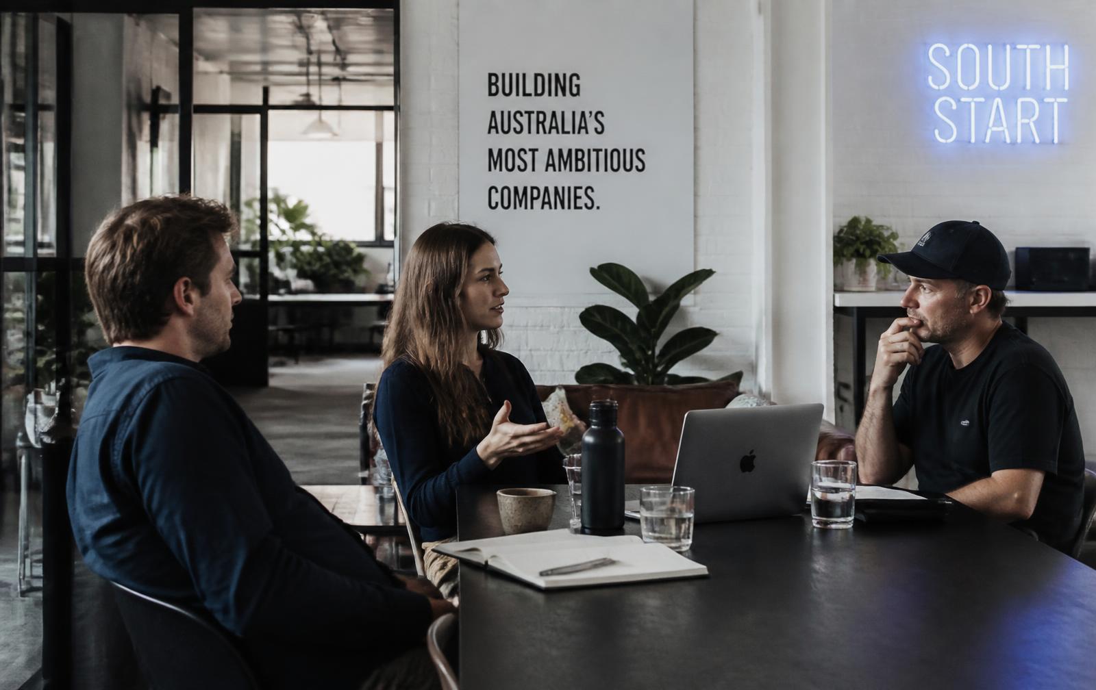 Australian founders in conversation around a workshop table